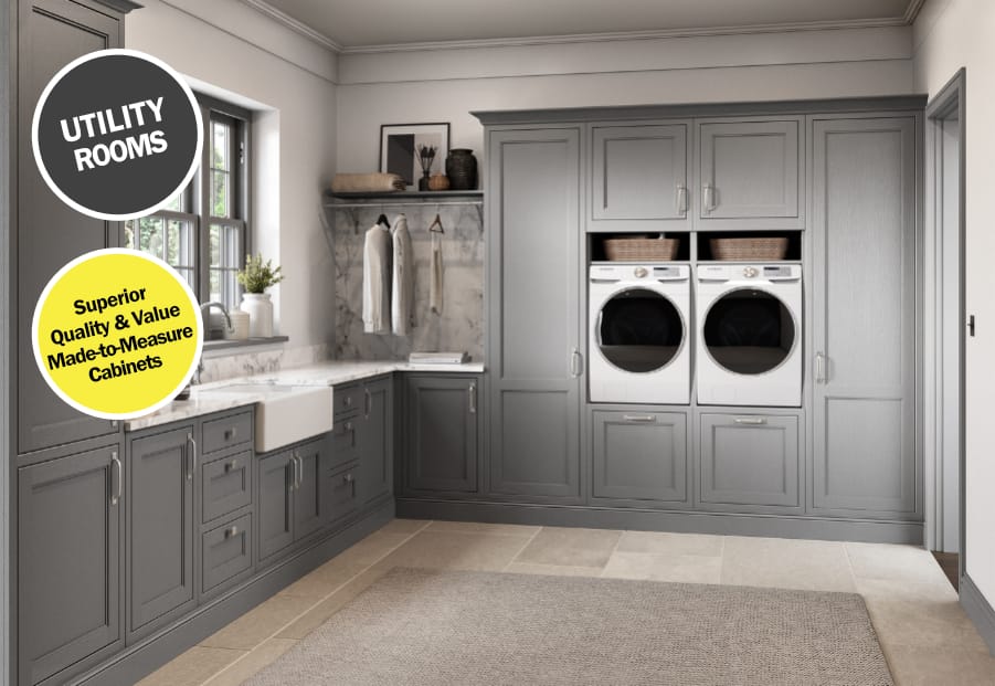 Stylish utility room design featuring bespoke grey cabinetry, integrated appliances, and a farmhouse sink. The layout includes made-to-measure storage solutions, marble countertops, and practical hanging space, blending functionality with timeless elegance. The room is enhanced by natural light, tiled flooring, and superior craftsmanship for a sophisticated, organised space.